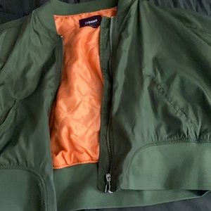 green bomber jacket with orange inside